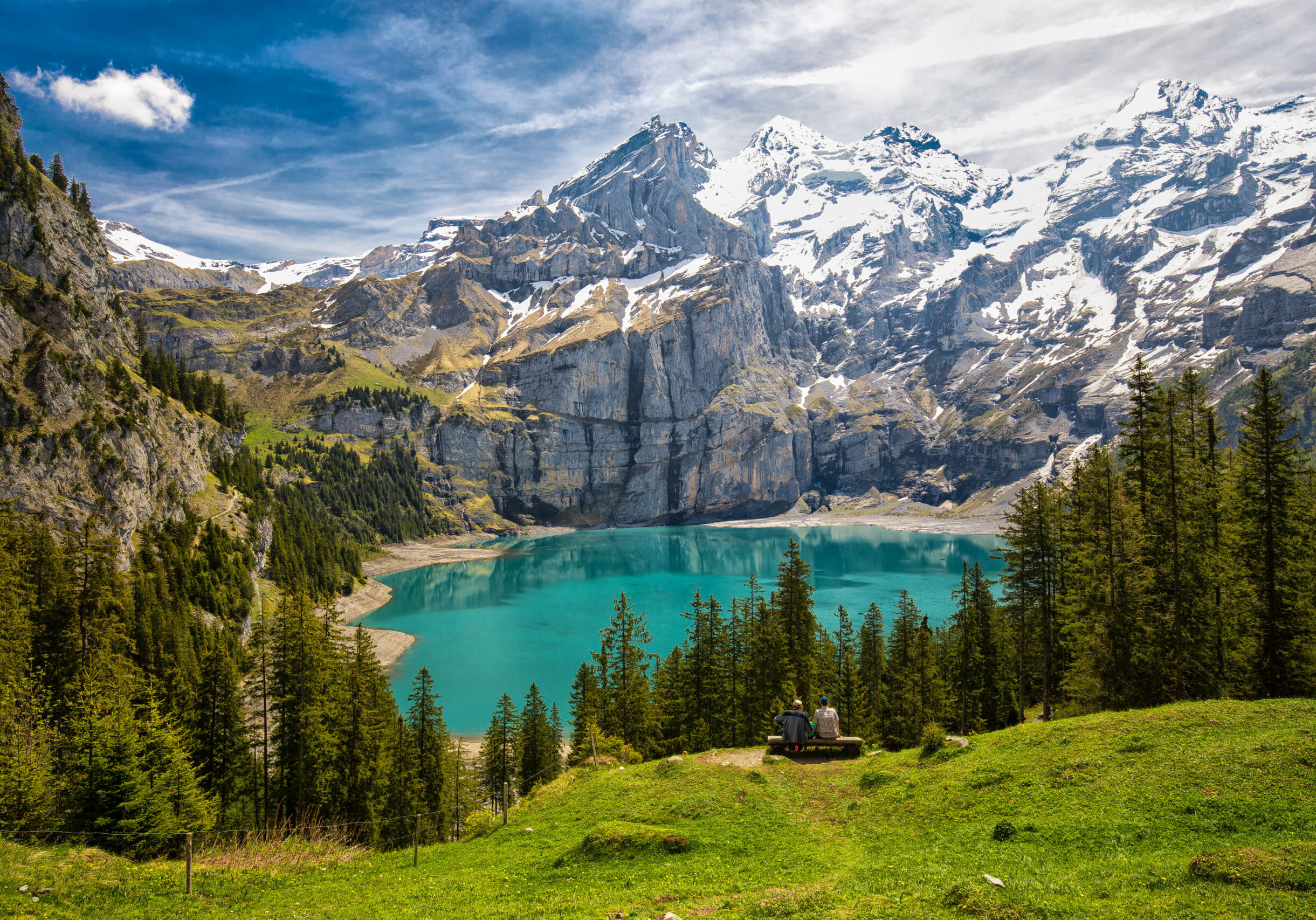 Amazing tourquise Oeschinnensee with waterfalls, wooden chalet and Swiss Alps, Berner Oberland, Switzerland.